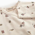 Long-sleeved onesie with feet and pattern for a newborn baby