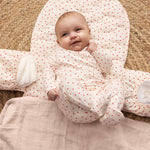 Baby on a puzzle mat with a cute heart print