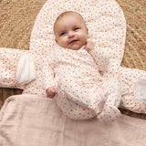 Baby on a puzzle mat with a cute heart print