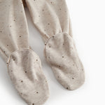 Beige baby pants with feet for newborns with a sweet print