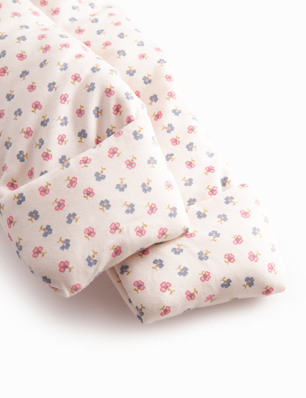 The hat is designed for newborns with a brim, snap closure, and flower pattern.