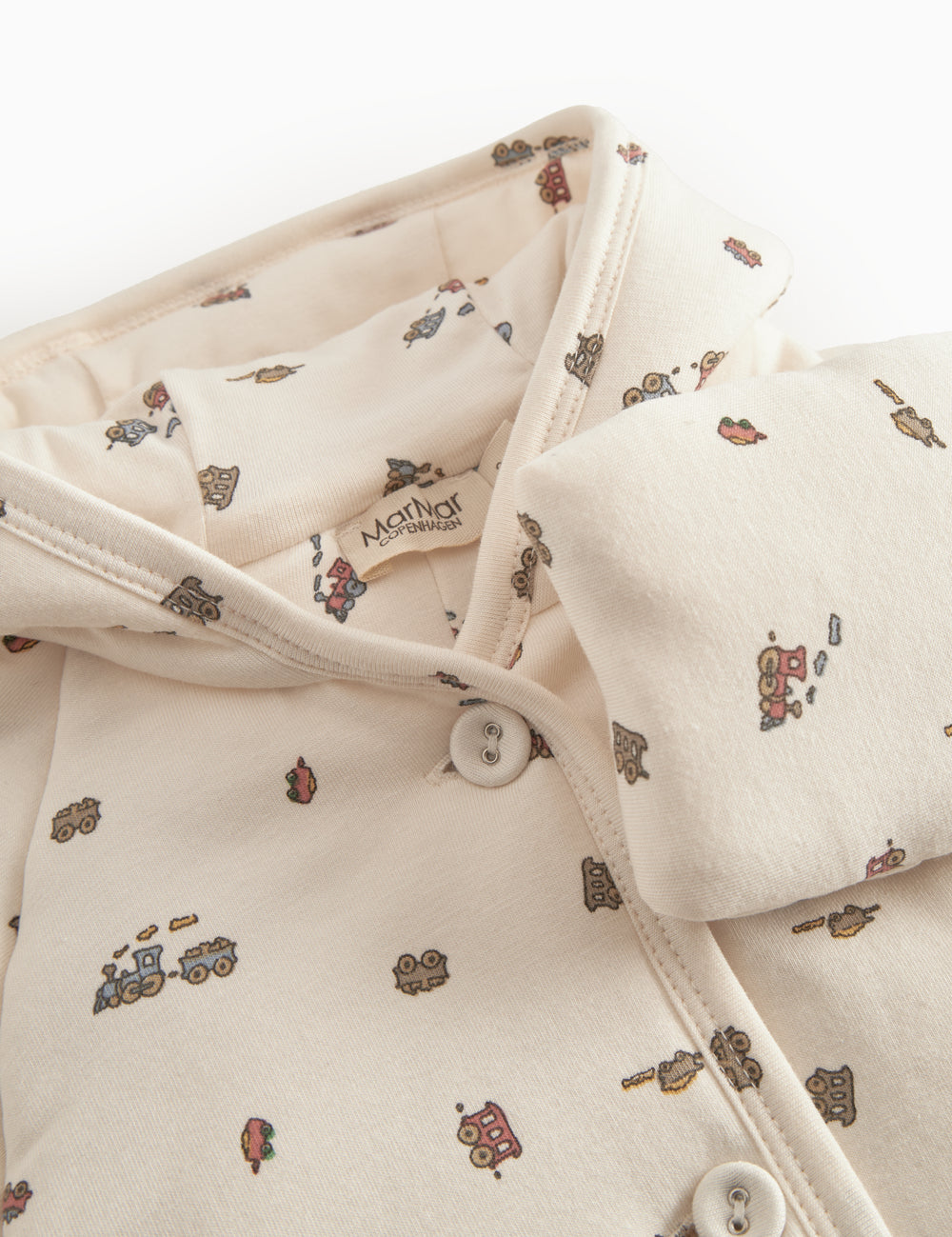 The hat is designed for newborns with a brim, snap closure, and train pattern.