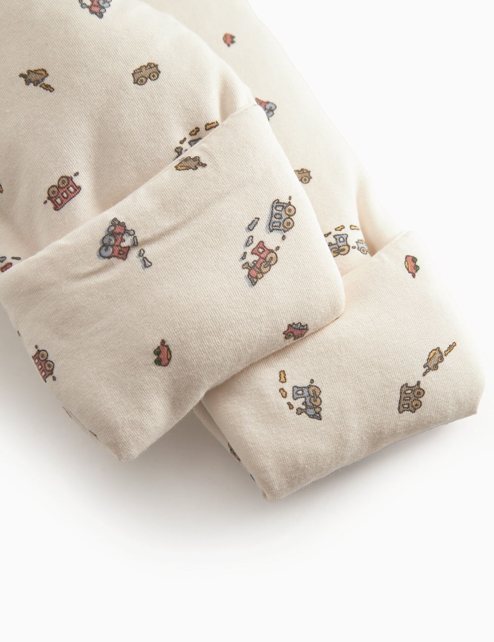 The hat is designed for newborns with a brim, snap closure, and train pattern.