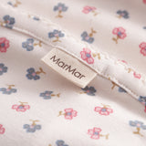 Baby blanket with rounded corners, picot edges, and floral print.