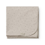 Beige baby blanket with rounded corners, picot edges, and a fine print.