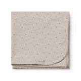 Beige baby blanket with rounded corners, picot edges, and a fine print.