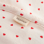 Baby blanket with rounded corners, picot edges, and a fine heart print.