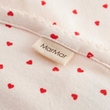 Baby blanket with rounded corners, picot edges, and a fine heart print.