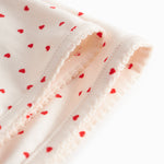 Baby blanket with rounded corners, picot edges, and a fine heart print.