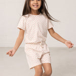 Wearing shorts and a t-shirt with a nice heart print.