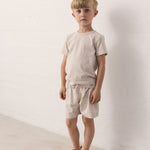 Boy wearing shorts and a t-shirt with a nice print