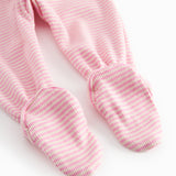Red striped pants with feet for a newborn baby
