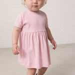 Child wearing a striped dress with loose fit