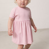 Child wearing a striped dress with loose fit