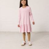 Child wearing a striped dress with long sleeves.