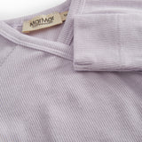 Lightly lined light purple shirt for newborns with a snap closure.