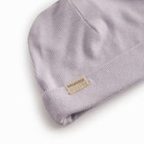 Light pink hat for newborn with edge that can be folded up or down.