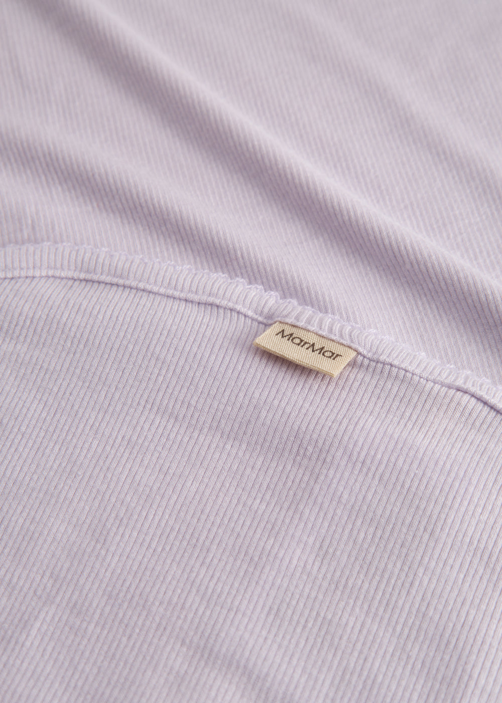 Light pink baby blanket with rounded corners and picot edges.