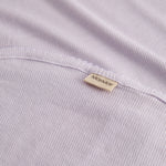 Light pink baby blanket with rounded corners and picot edges.