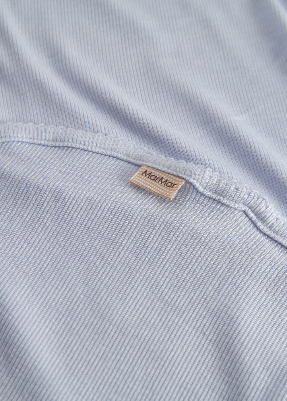 Light blue baby blanket with rounded corners and picot edges