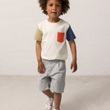 Children wearing a white T-shirt with contrast sleeves and a pocket.