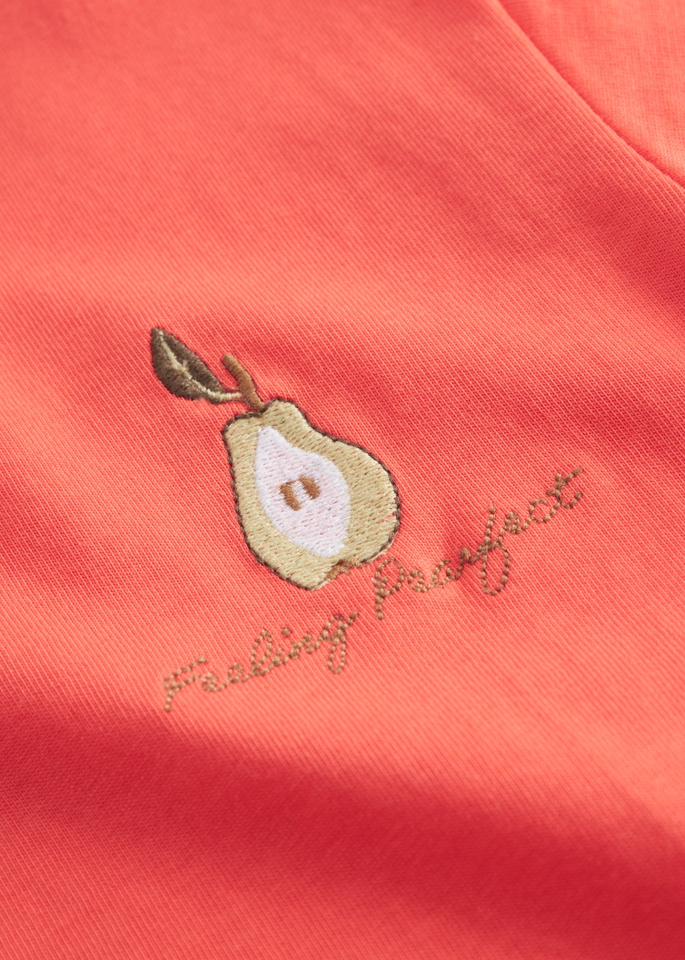 Orange children's T-shirt with small embroidered fruit motif