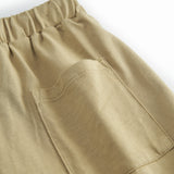 Beige children's shorts with wide elastic and ribbons.