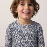 Boy wearing a blue long-sleeved leopard t-shirt