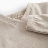 Beige sweatshirt for baby with diagonal button closure.