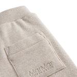 Beige baby sweatpants with elastic waist.