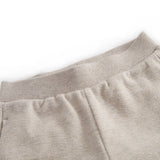 Beige baby sweatpants with elastic waist.