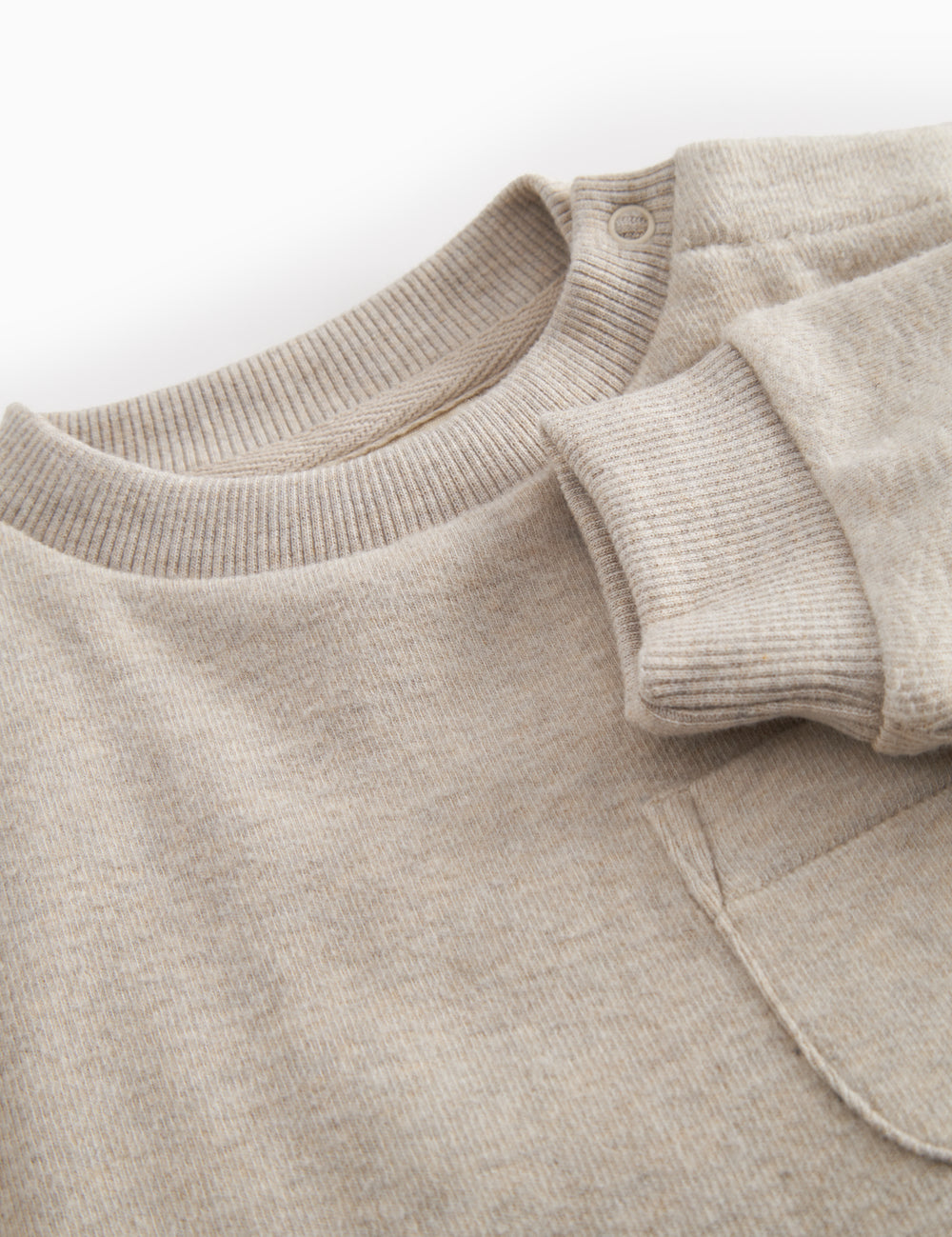 Beige baby onesie with ribbing on the neck, sleeves, and legs.