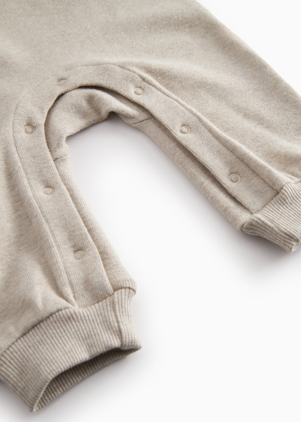 Beige baby onesie with ribbing on the neck, sleeves, and legs.