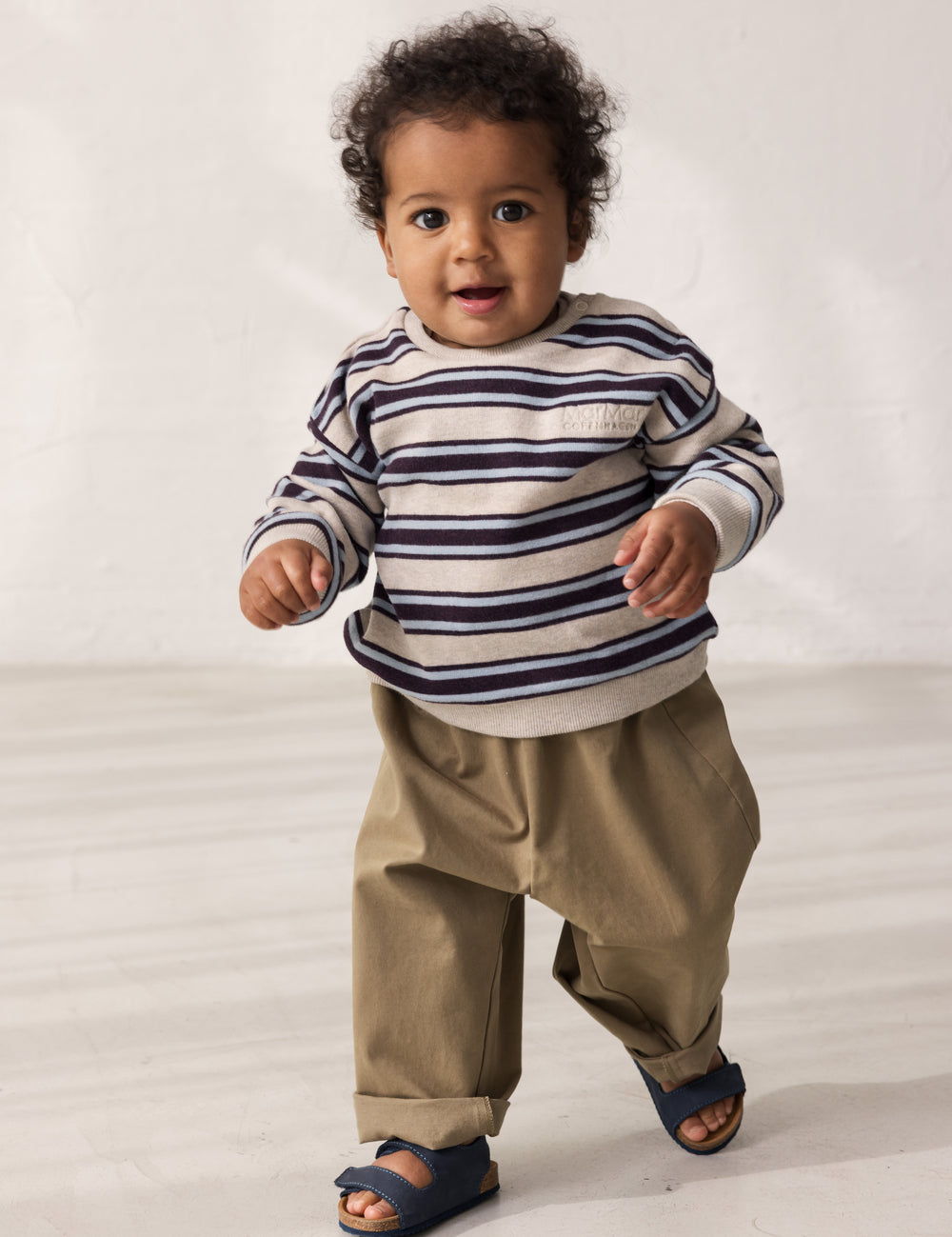 Baby wearing striped sweatshirt with logo embroidery