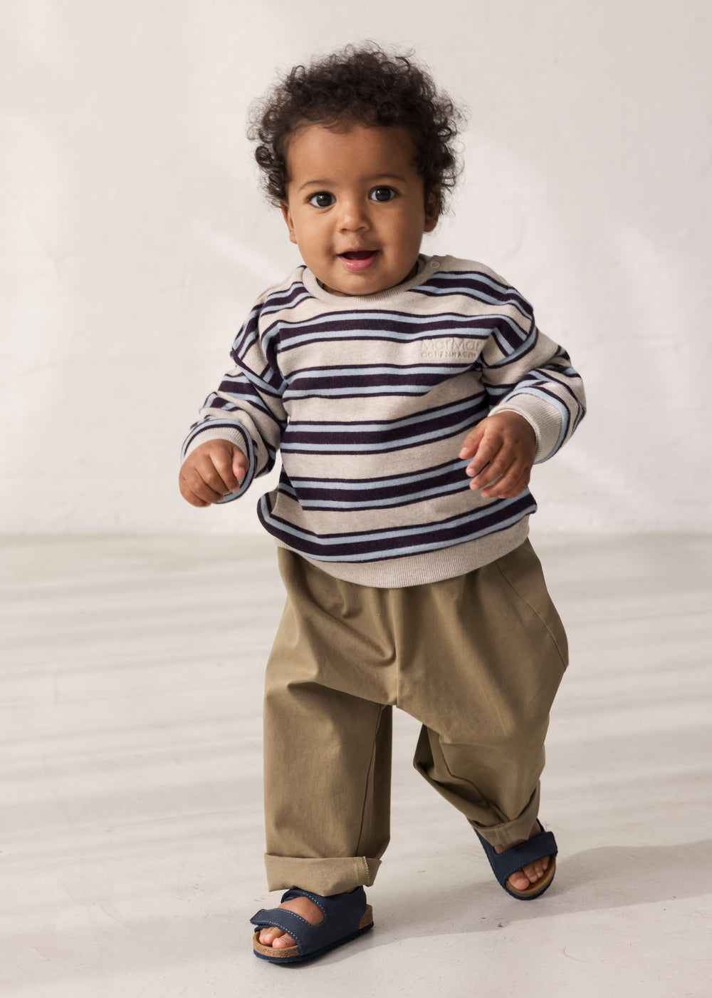 Baby wearing striped sweatshirt with logo embroidery