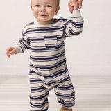 Baby wearing a long-sleeved striped sweater with ribbing in the neck, sleeves, and legs.