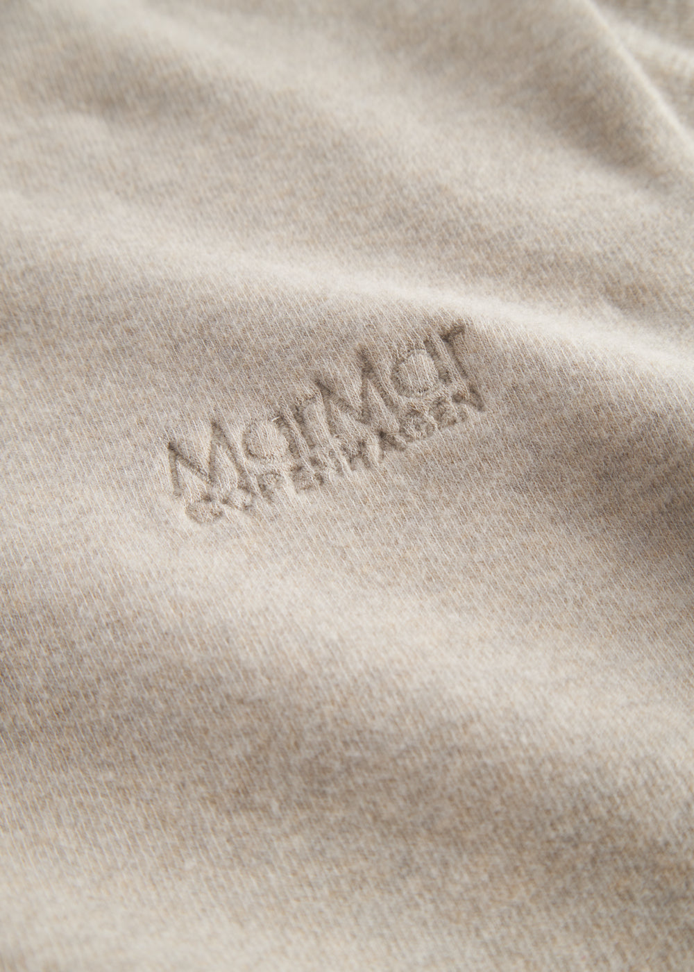 Beige long-sleeved sweatshirt for children with ribbed cuffs.