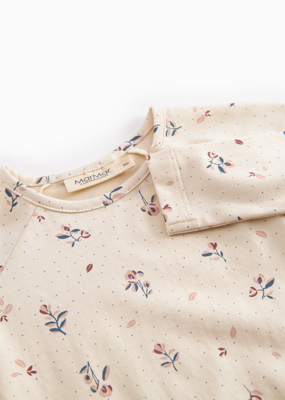 Langärmet baby bodystocking with floral print and snap closure