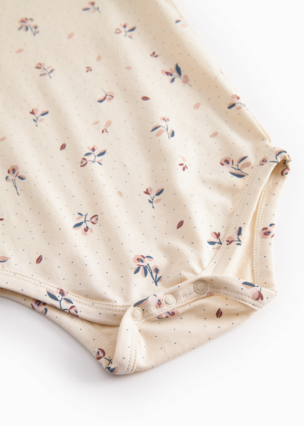 Langärmet baby bodystocking with floral print and snap closure