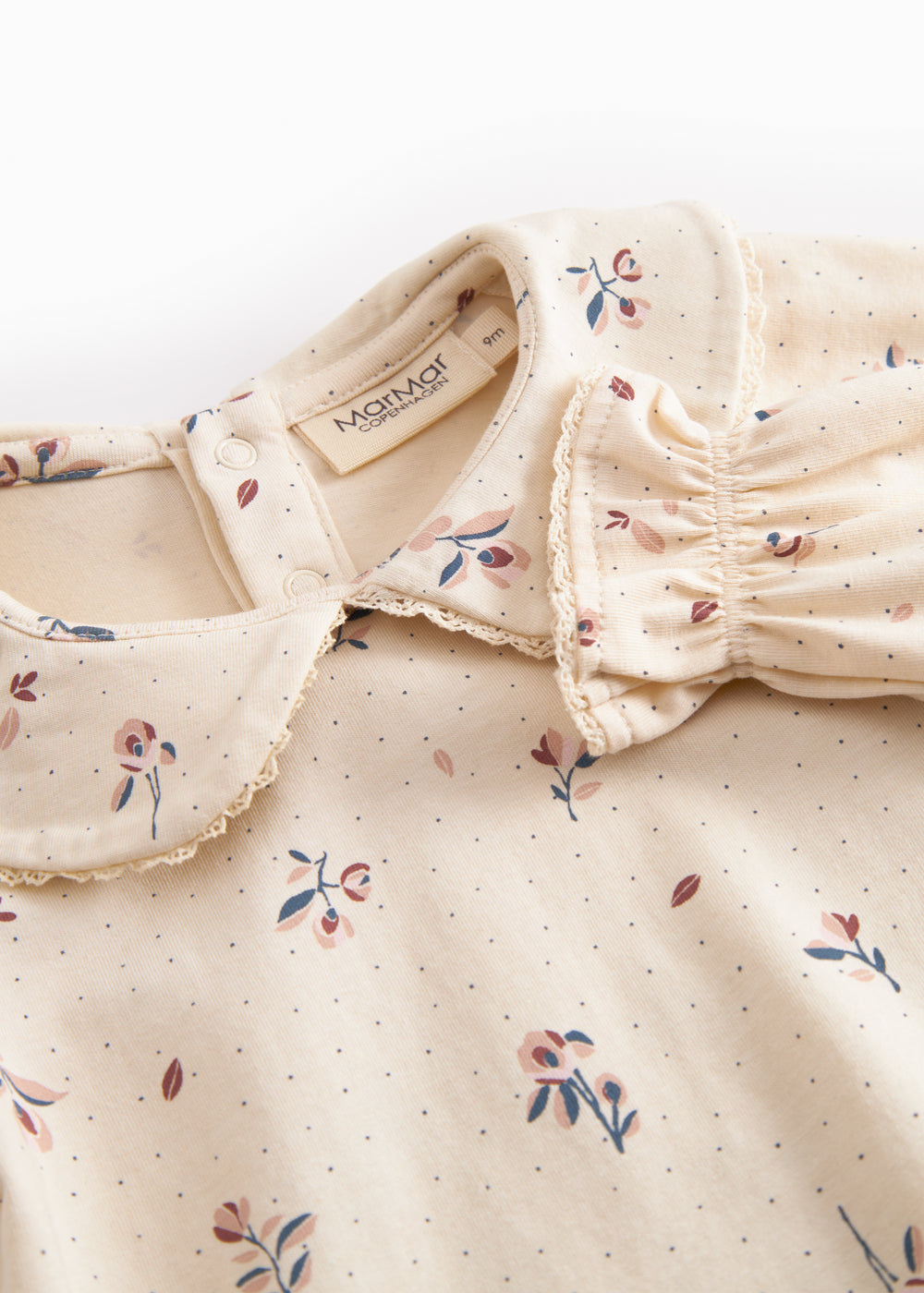 Langärmet baby bodystocking with floral print and collar