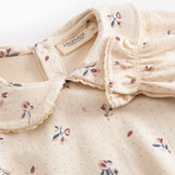 Langärmet baby bodystocking with floral print and collar