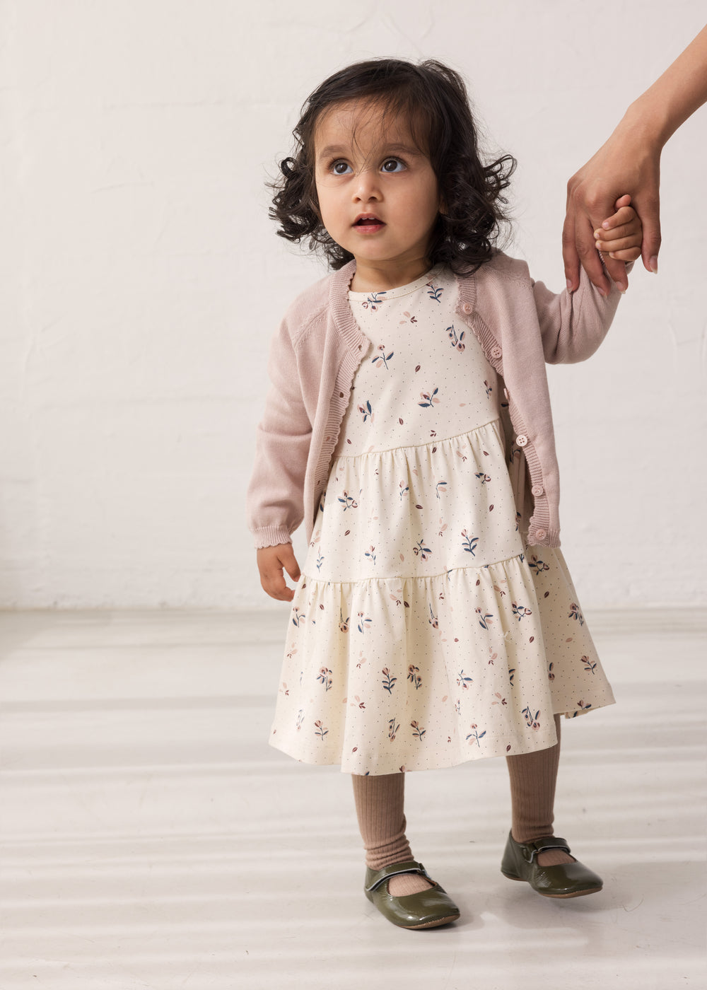 Wearing a long-sleeved layered dress with a floral print.