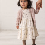 Wearing a long-sleeved layered dress with a floral print.