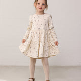 Wearing a long-sleeved layered dress with a floral print.