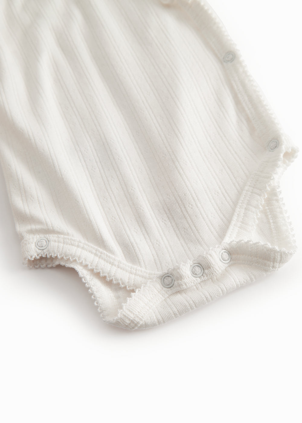 Langærmet hvid pointelle bodystocking til nyfødte