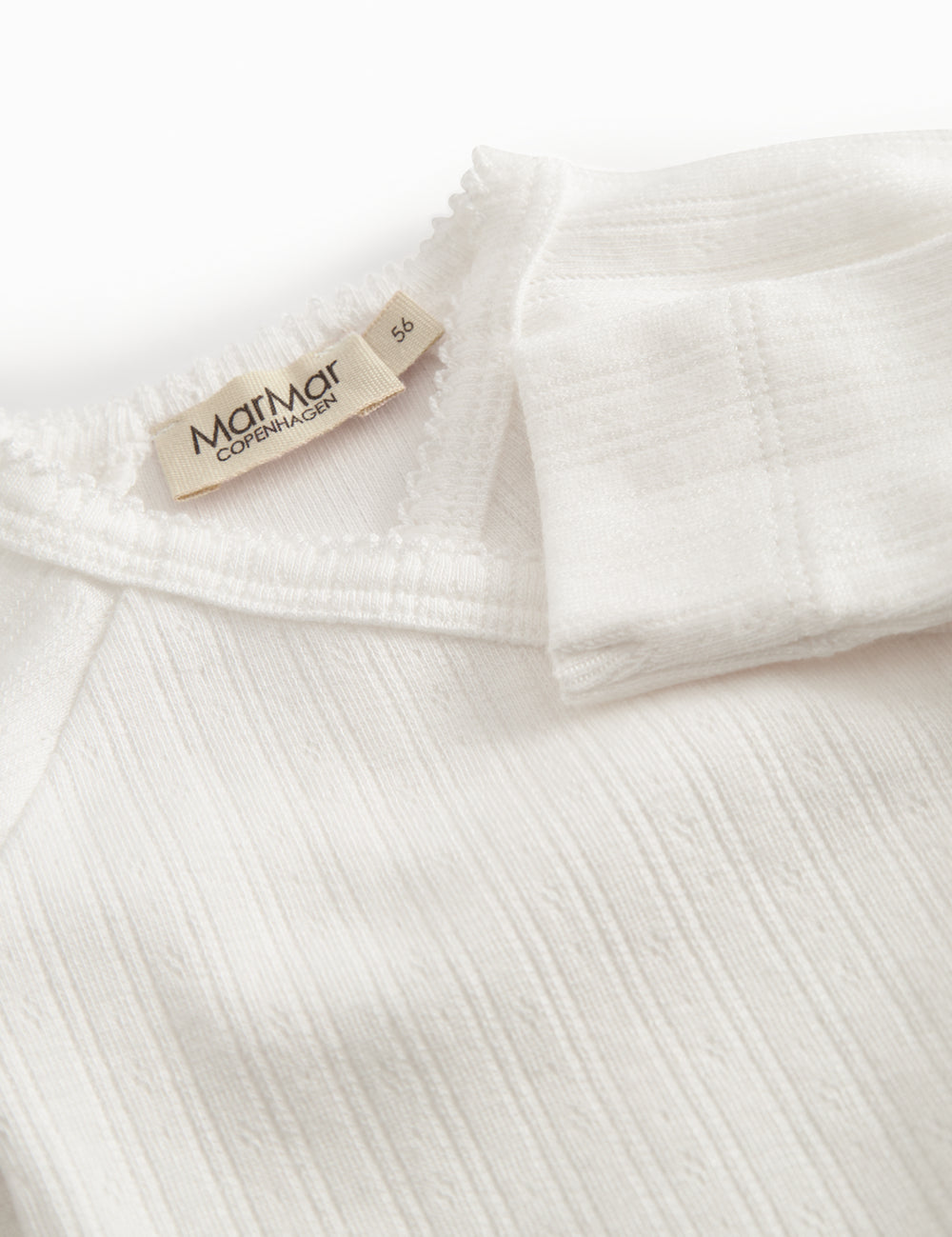 Fleece pointelle blouse for newborns with a wrap-around closure.