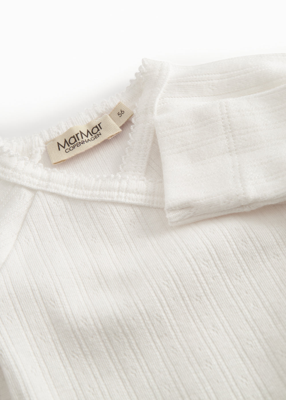 Fleece pointelle blouse for newborns with a wrap-around closure.