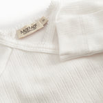 Fleece pointelle blouse for newborns with a wrap-around closure.