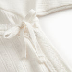 Langærmet pointelle bluse til nyfødte med slå-om-lukning