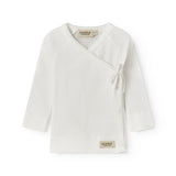 Fleece pointelle blouse for newborns with a wrap-around closure.